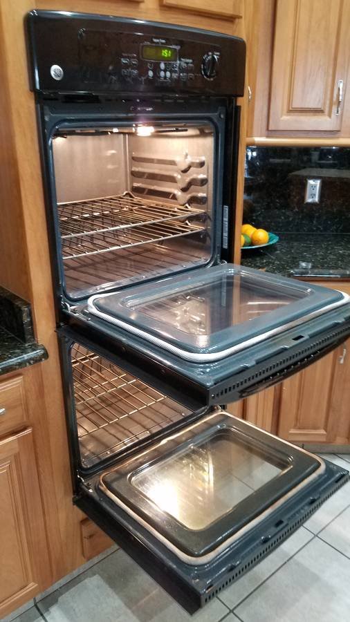Oven repair technician servicing a GE oven in Bonita, San Diego