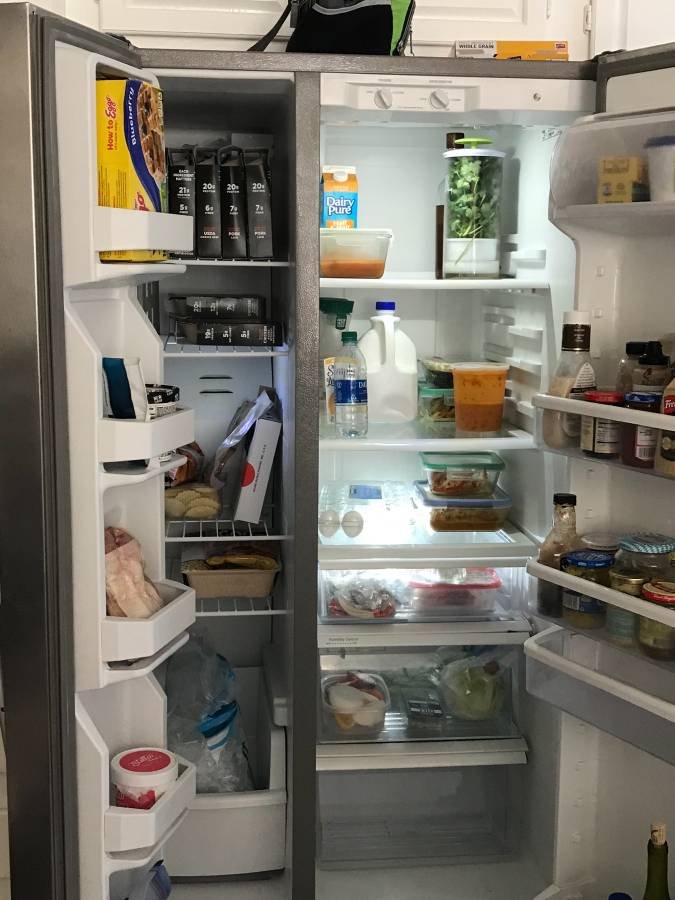 Refrigerator repair technician in a Chula Vista kitchen